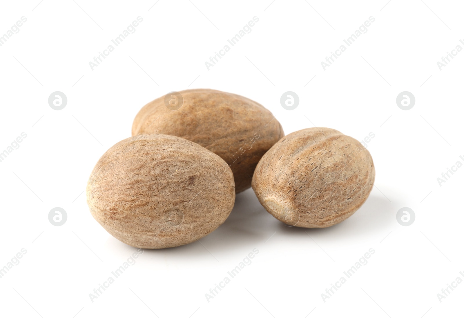 Photo of Three whole fresh nutmegs isolated on white