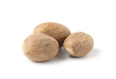 Photo of Three whole fresh nutmegs isolated on white