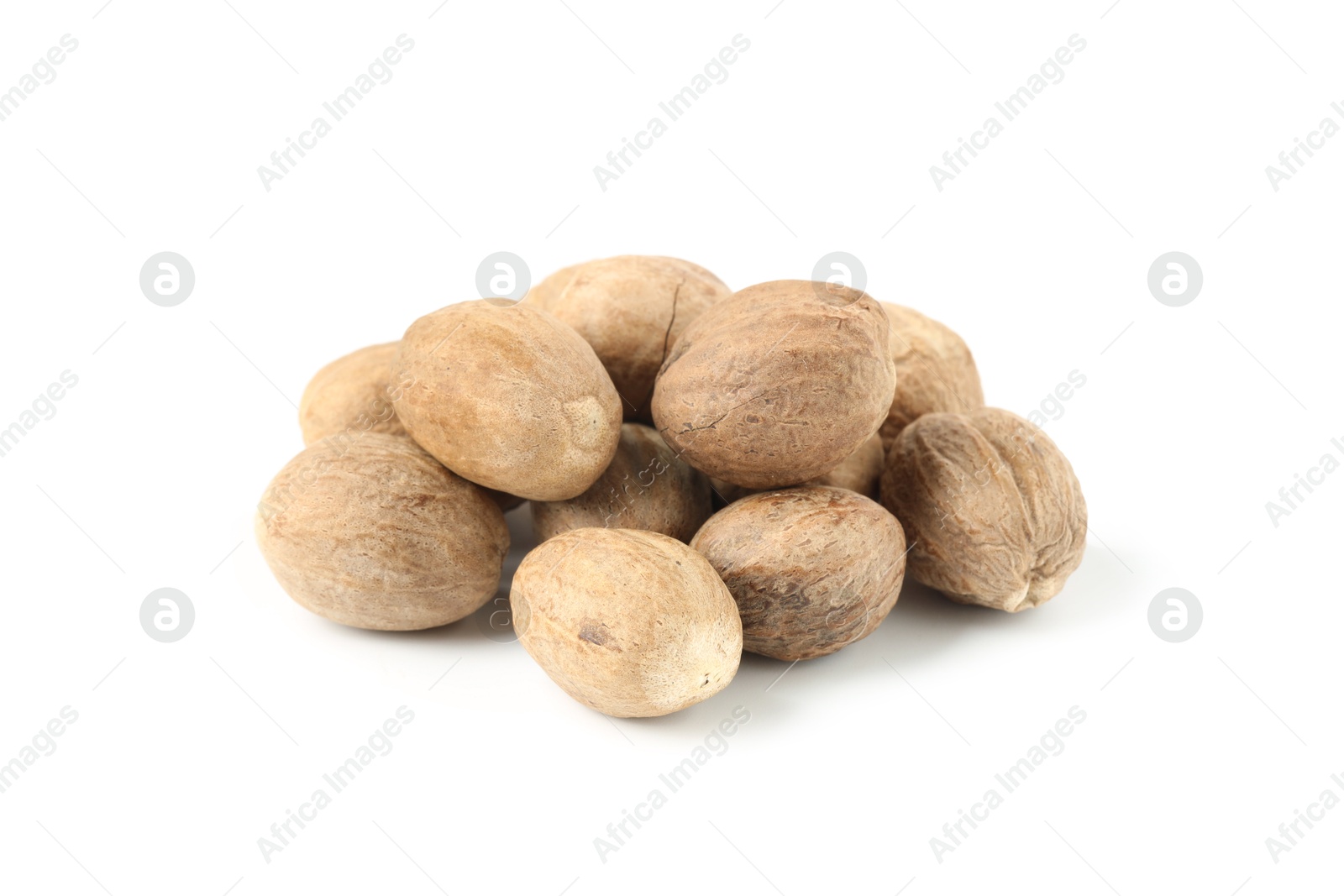 Pile of fresh nutmegs isolated on white Photo of Pile of fresh nutmegs isolated on white