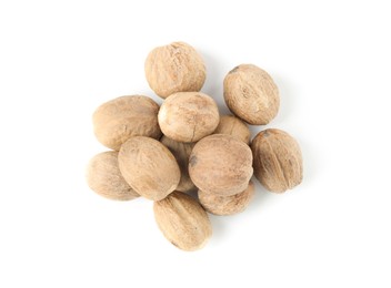 Photo of Fresh nutmegs isolated on white, top view