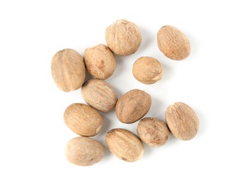 Photo of Fresh nutmegs isolated on white, top view