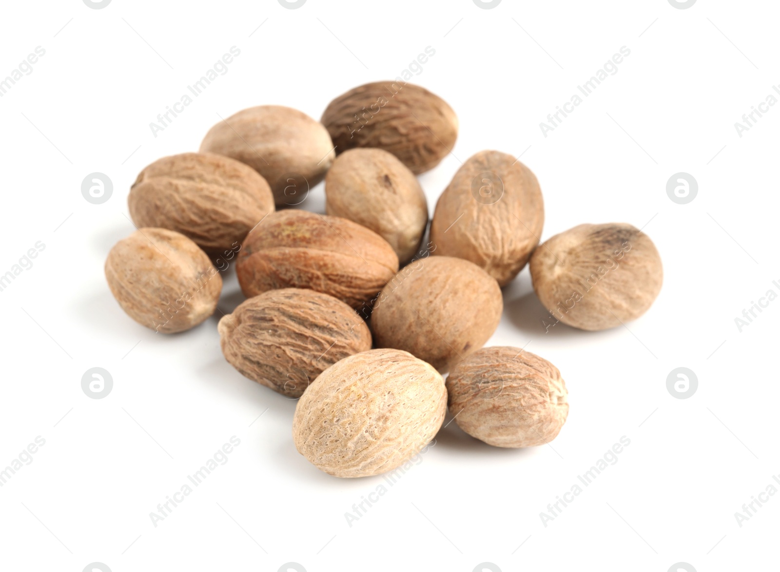 Pile of fresh nutmegs isolated on white Photo of Pile of fresh nutmegs isolated on white