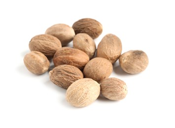 Photo of Pile of fresh nutmegs isolated on white