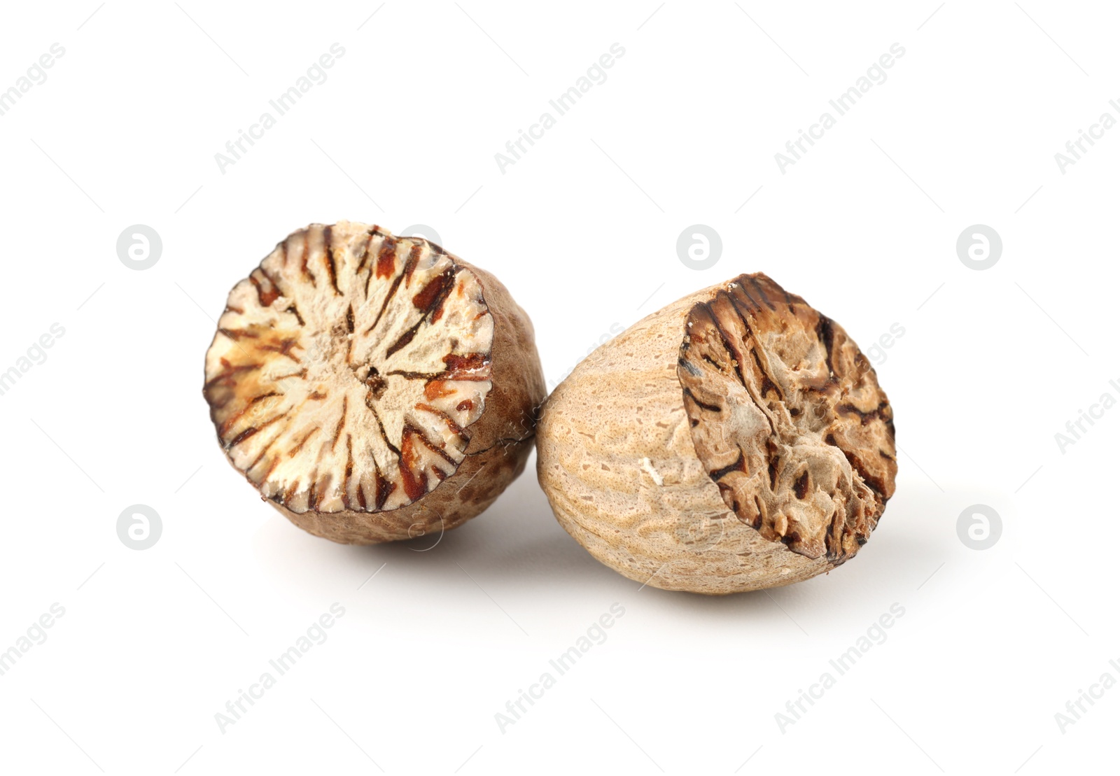 Halves of fresh nutmeg isolated on white Photo of Halves of fresh nutmeg isolated on white