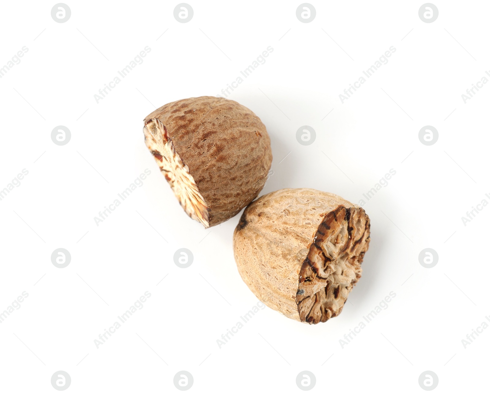 Halves of fresh nutmeg isolated on white, top view Photo of Halves of fresh nutmeg isolated on white, top view