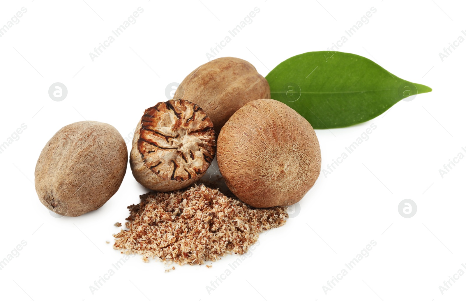 Whole, cut nutmegs, powder and leaf isolated on white Photo of Whole, cut nutmegs, powder and leaf isolated on white