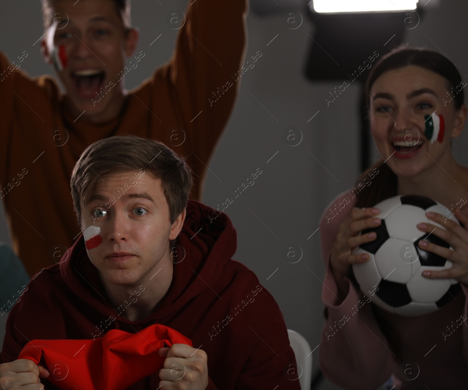 Emotional sports fans watching game together indoors, selective focus Photo of Emotional sports fans watching game together indoors, selective focus