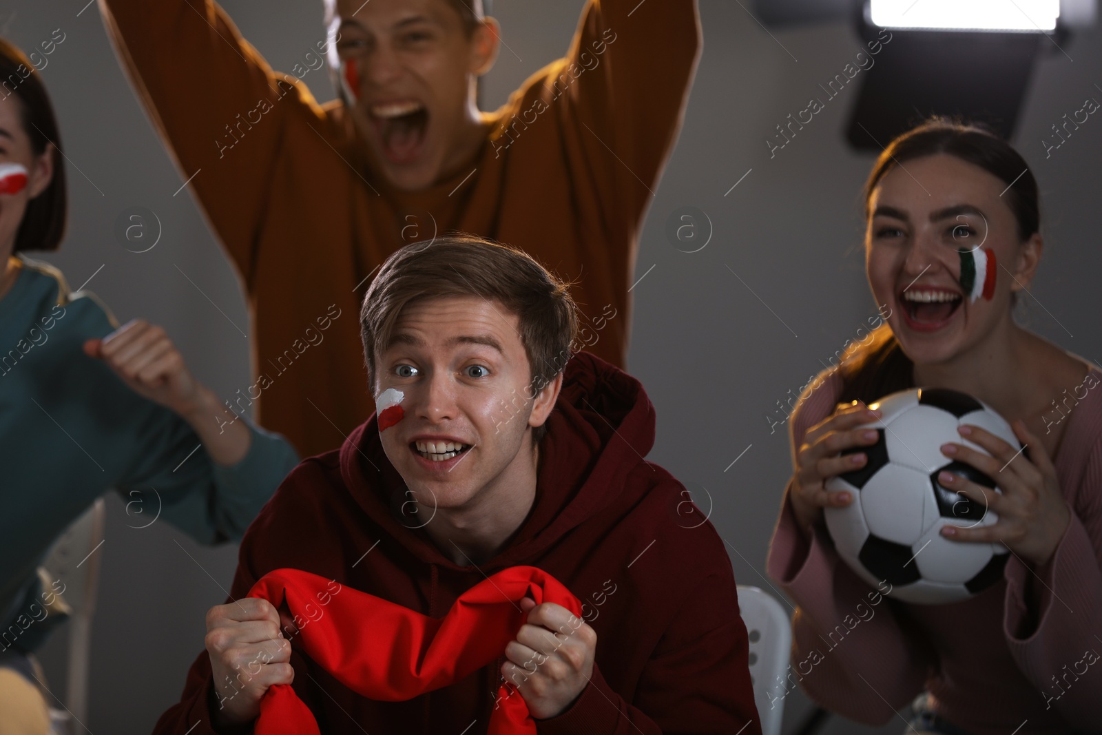 Emotional sports fans watching game together indoors, selective focus Photo of Emotional sports fans watching game together indoors, selective focus