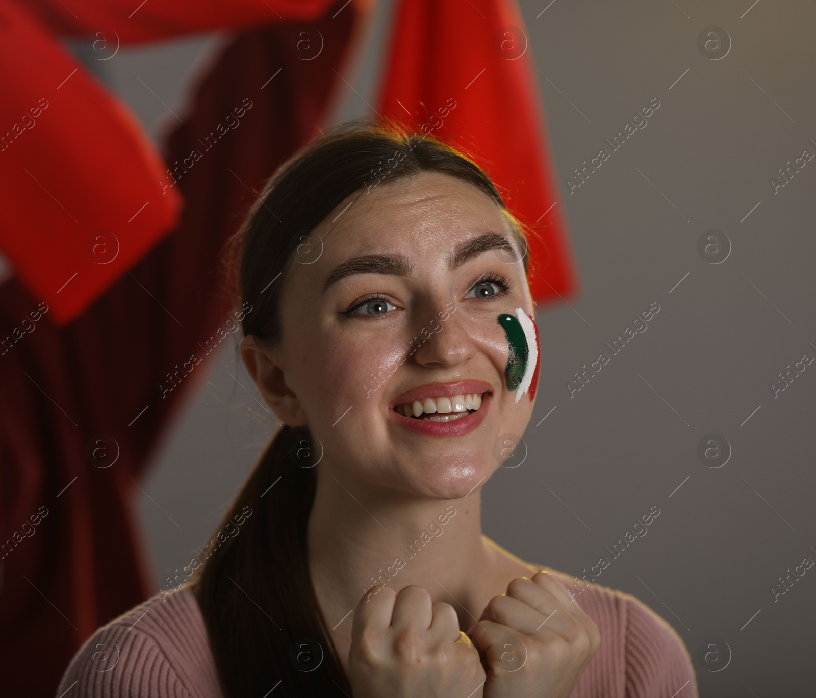 Emotional sports fan with drawing of Italian flag watching game indoors Photo of Emotional sports fan with drawing of Italian flag watching game indoors