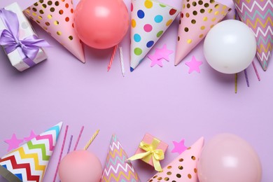 Photo of Beautiful party hats and other festive decor on lilac background, flat lay. Space for text