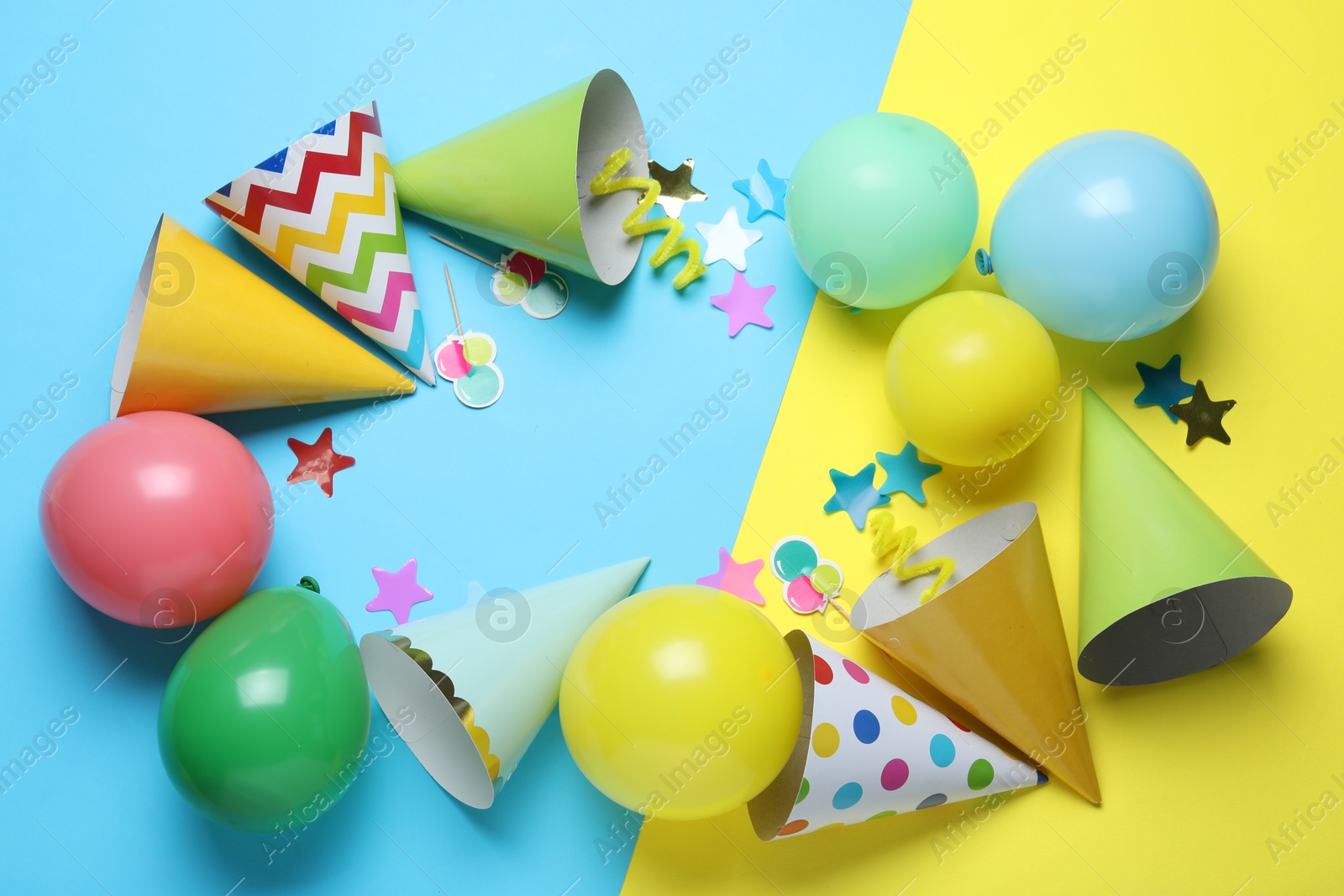 Beautiful party hats and other festive decor on color background, flat lay. Space for text Photo of Beautiful party hats and other festive decor on color background, flat lay. Space for text
