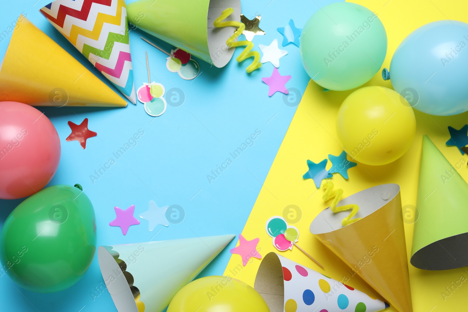 Beautiful party hats and other festive decor on color background, flat lay. Space for text Photo of Beautiful party hats and other festive decor on color background, flat lay. Space for text