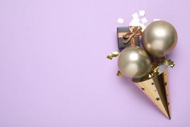 Photo of Beautiful party hat and other festive decor on violet background, flat lay. Space for text