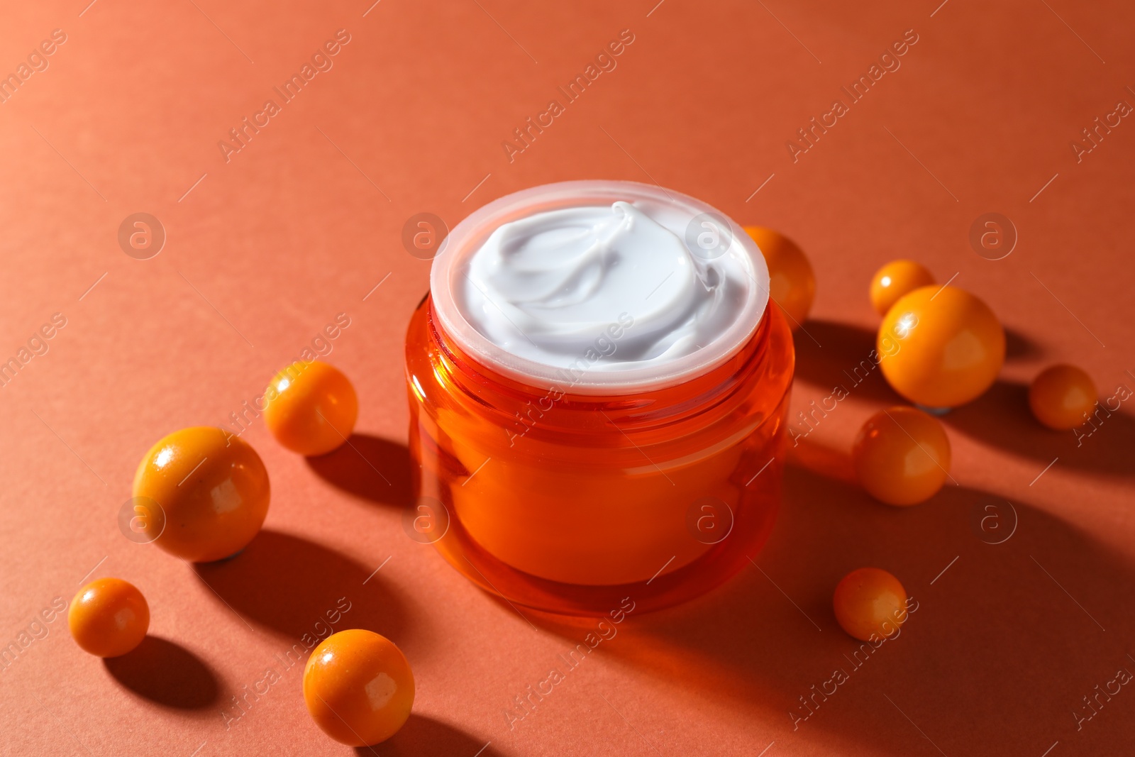 Jar of moisturizing body cream and balls on orange background, closeup Photo of Jar of moisturizing body cream and balls on orange background, closeup