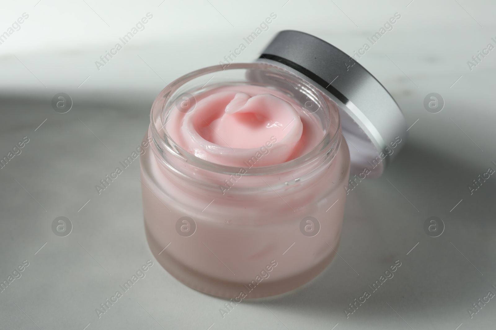 Jar of moisturizing body cream on white table, closeup Photo of Jar of moisturizing body cream on white table, closeup