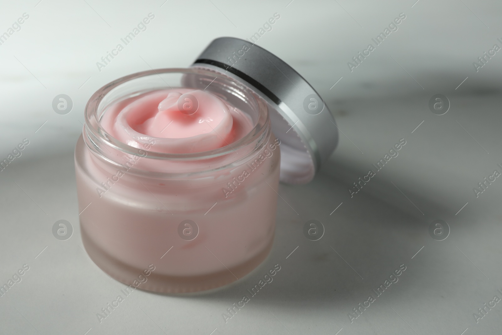 Jar of moisturizing body cream on white table, closeup Photo of Jar of moisturizing body cream on white table, closeup
