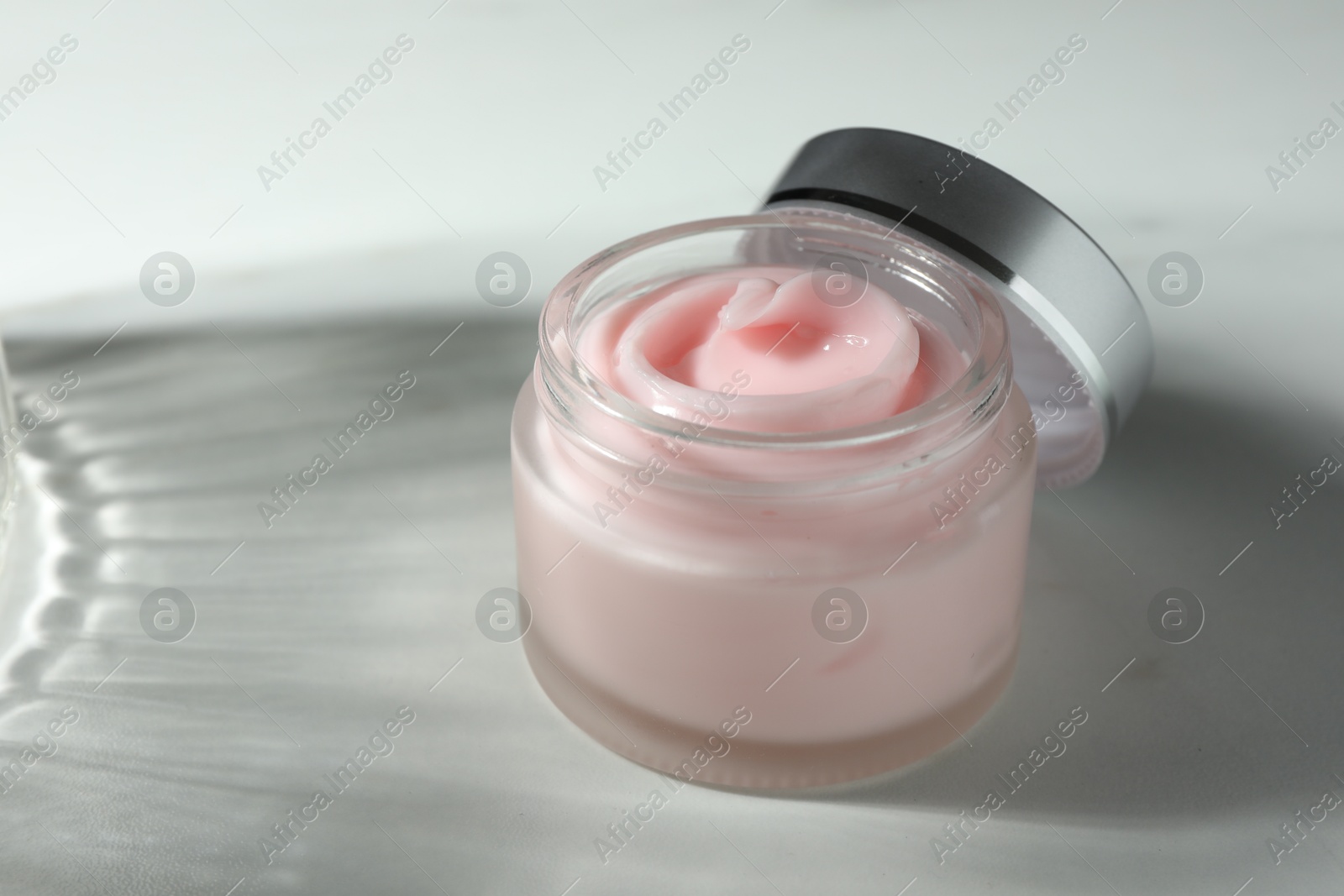 Jar of moisturizing body cream on white table, closeup Photo of Jar of moisturizing body cream on white table, closeup