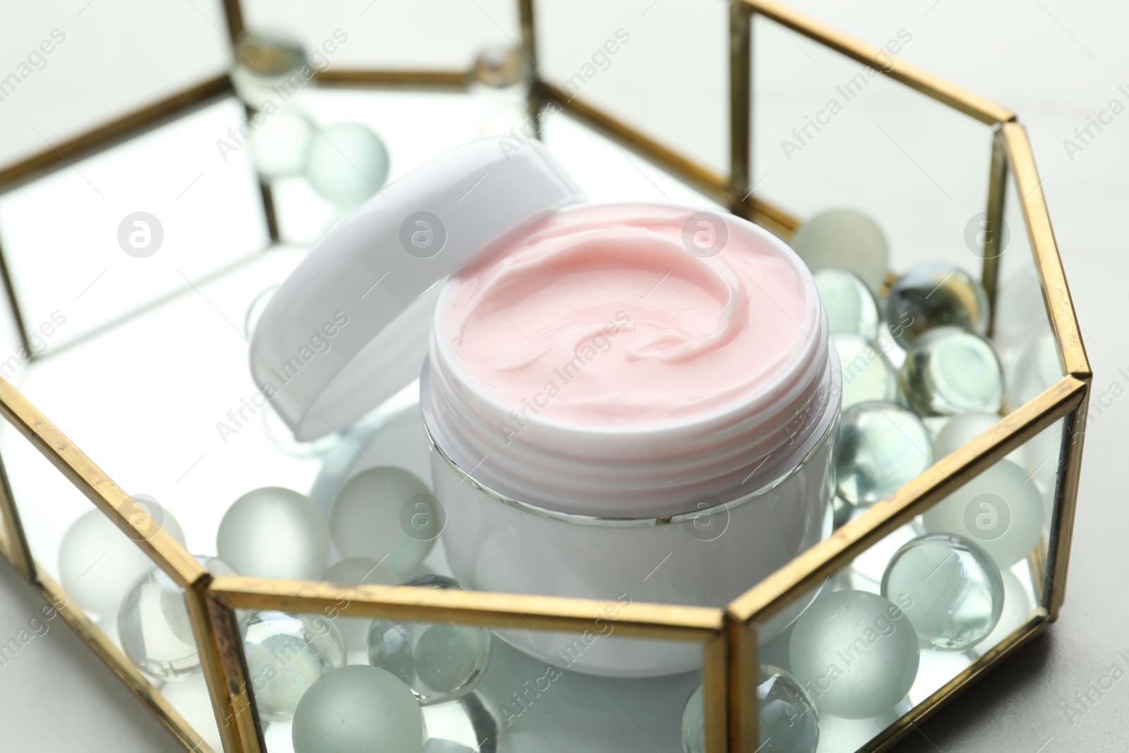 Jar of moisturizing body cream and glass tray on white table, closeup Photo of Jar of moisturizing body cream and glass tray on white table, closeup