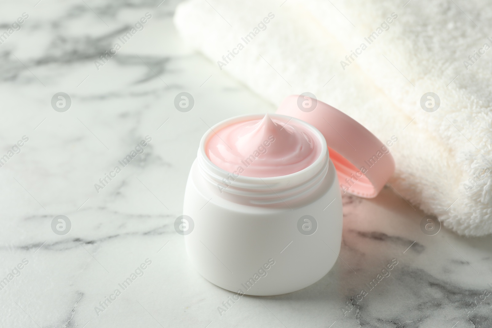Jar of moisturizing body cream on white marble table, closeup. Space for text Photo of Jar of moisturizing body cream on white marble table, closeup. Space for text