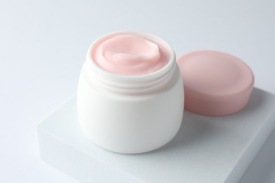 Photo of Jar of moisturizing body cream on white background, closeup