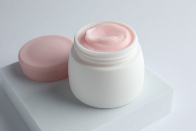 Photo of Jar of moisturizing body cream on white background, closeup