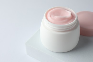 Photo of Jar of moisturizing body cream on white background, closeup. Space for text