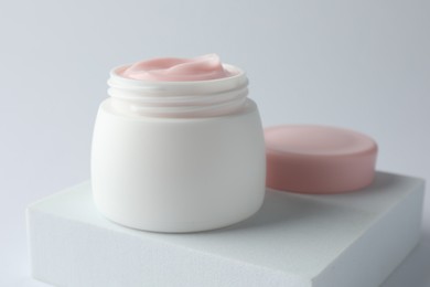 Photo of Jar of moisturizing body cream on white background, closeup
