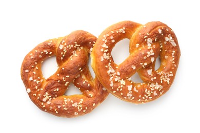 Photo of Tasty pretzels with salt isolated on white, top view