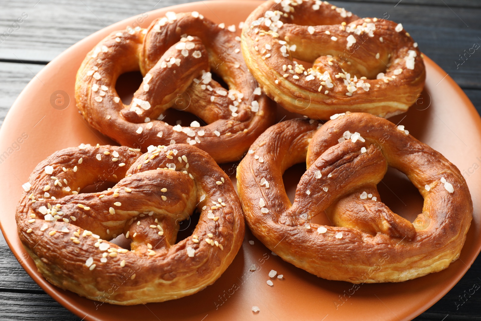 Tasty pretzels with salt on table, closeup Photo of Tasty pretzels with salt on table, closeup