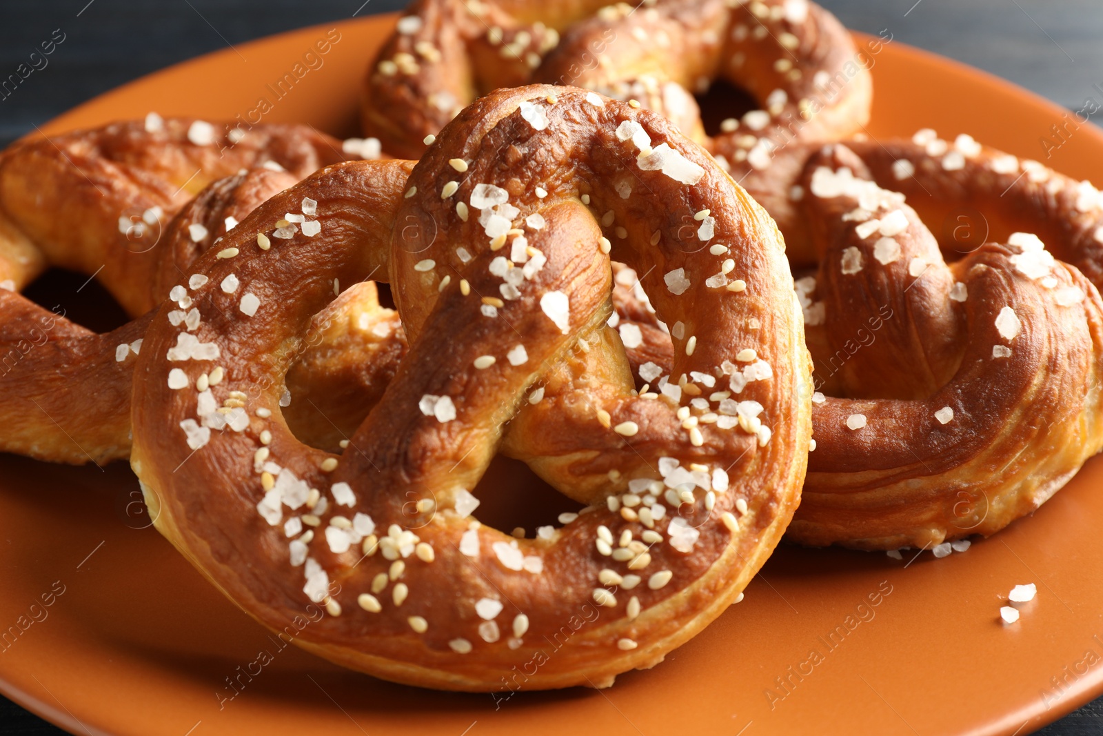 Tasty pretzels with salt on table, closeup Photo of Tasty pretzels with salt on table, closeup