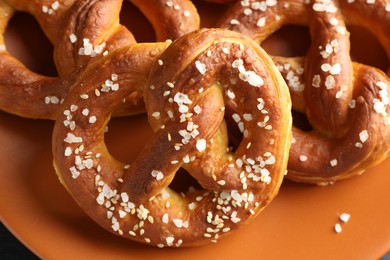 Photo of Tasty pretzels with salt on table, above view