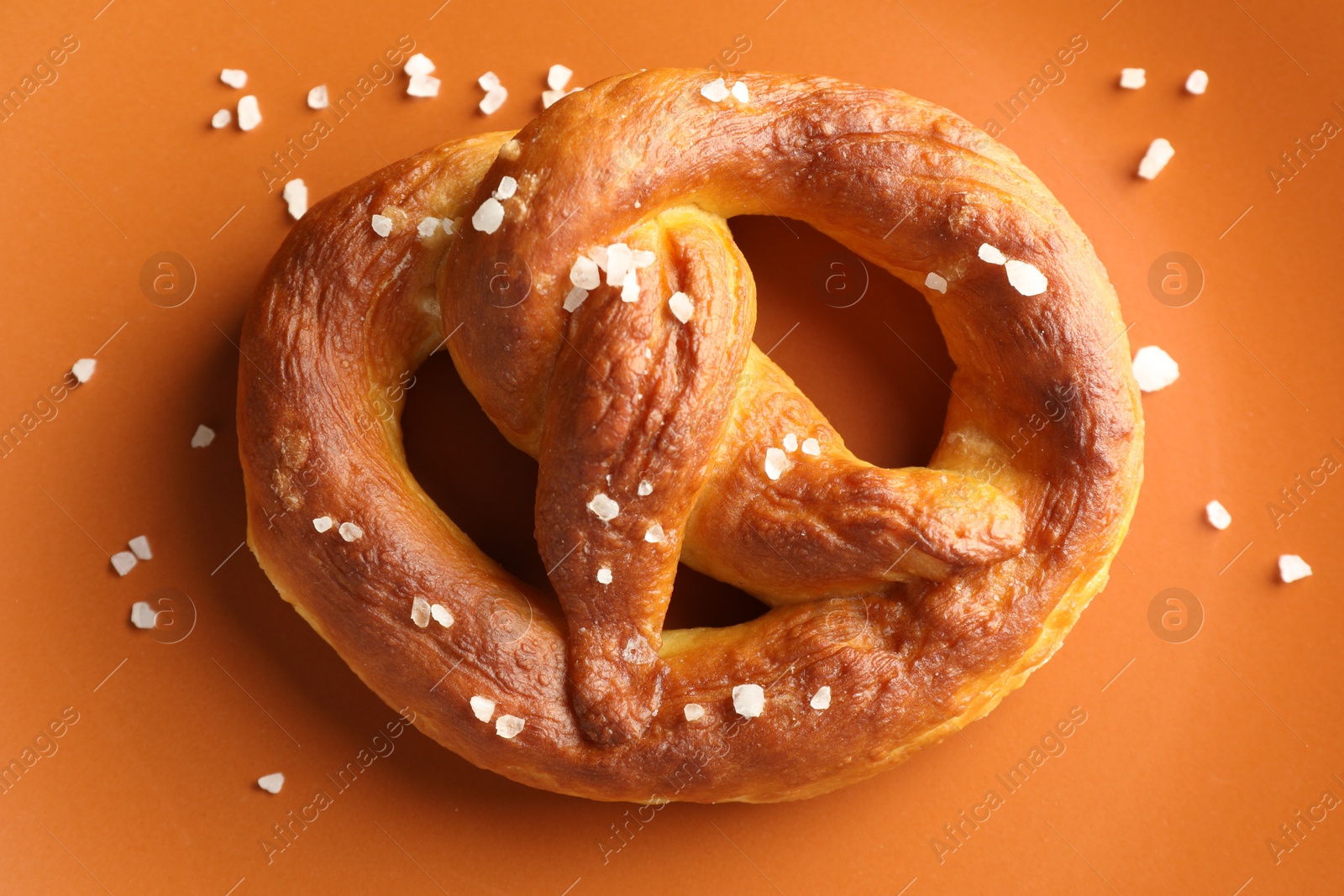 Tasty pretzels with salt on plate, top view Photo of Tasty pretzels with salt on plate, top view