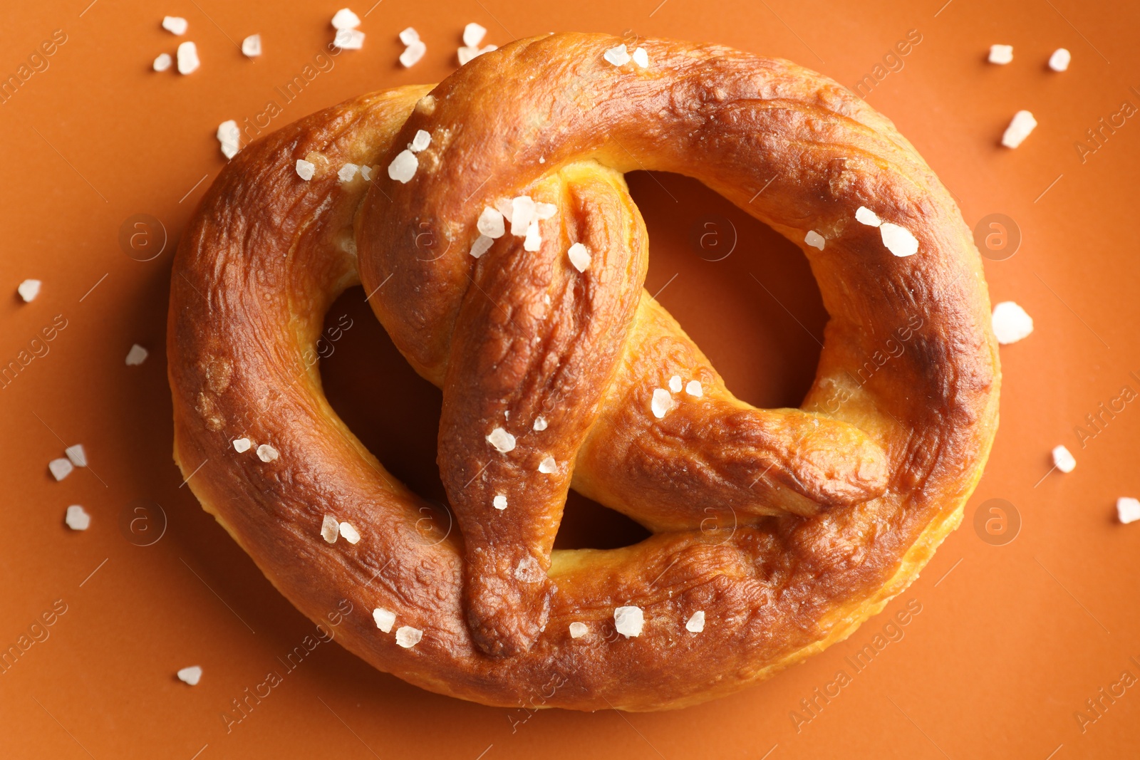 Tasty pretzels with salt on plate, top view Photo of Tasty pretzels with salt on plate, top view