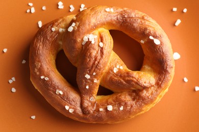 Photo of Tasty pretzels with salt on plate, top view