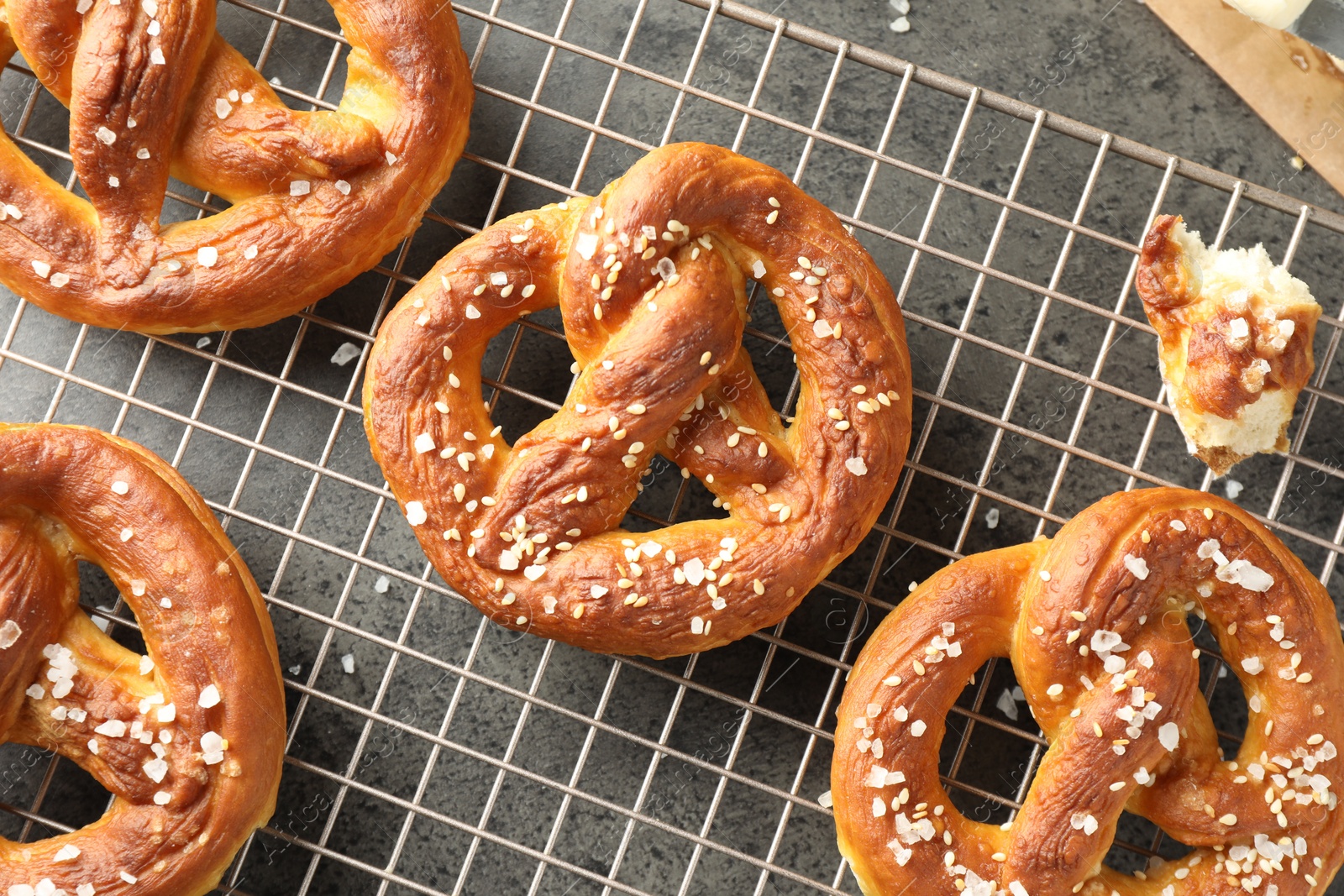 Tasty pretzels with salt on grey table, top view Photo of Tasty pretzels with salt on grey table, top view