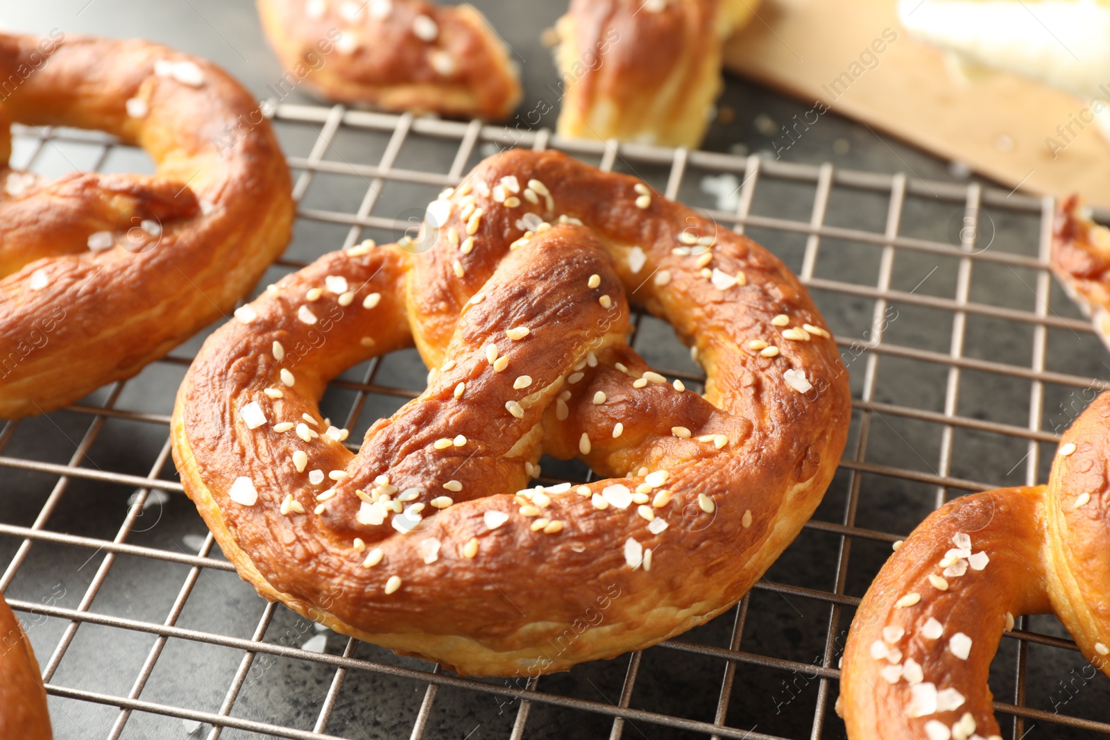 Tasty pretzels with salt on grey table, closeup Photo of Tasty pretzels with salt on grey table, closeup
