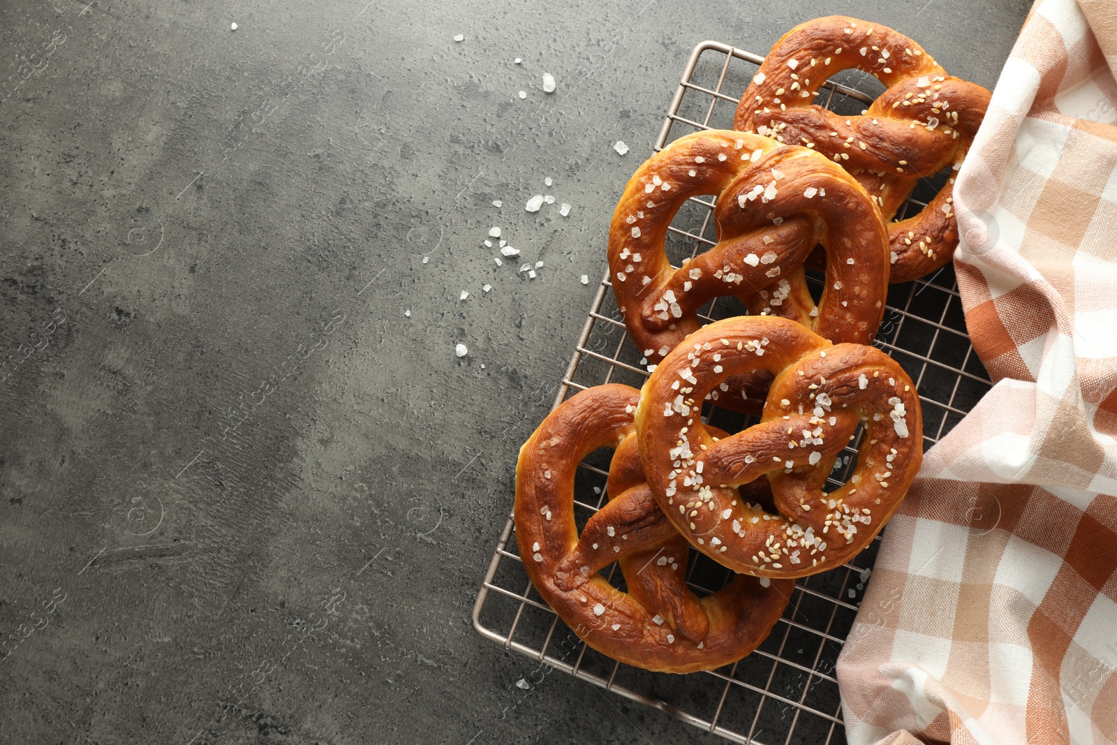 Tasty pretzels with salt on grey table, top view. Space for text Photo of Tasty pretzels with salt on grey table, top view. Space for text