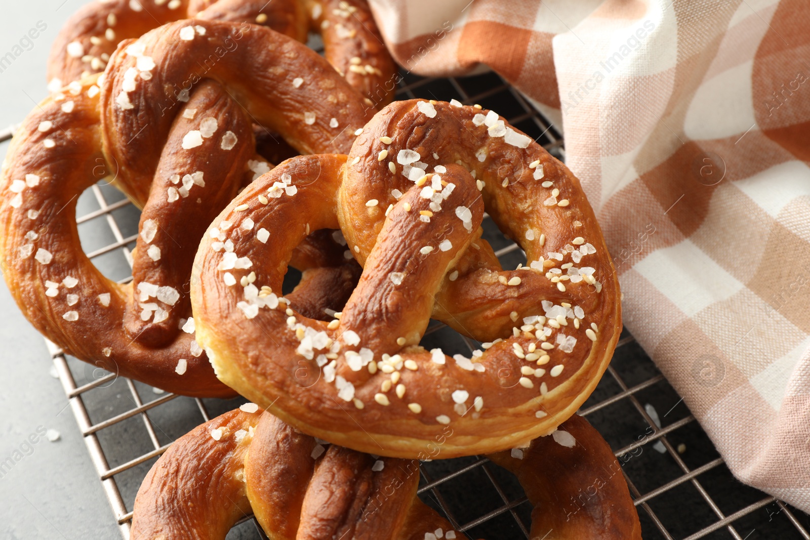 Tasty pretzels with salt on grey table, above view Photo of Tasty pretzels with salt on grey table, above view