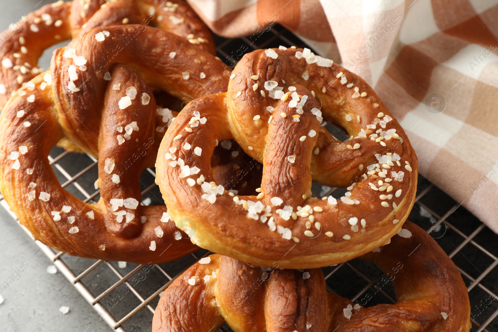 Tasty pretzels with salt on grey table, above view Photo of Tasty pretzels with salt on grey table, above view
