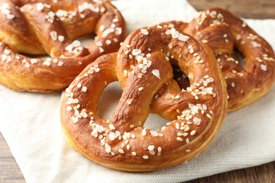 Photo of Tasty pretzels with salt on table, closeup