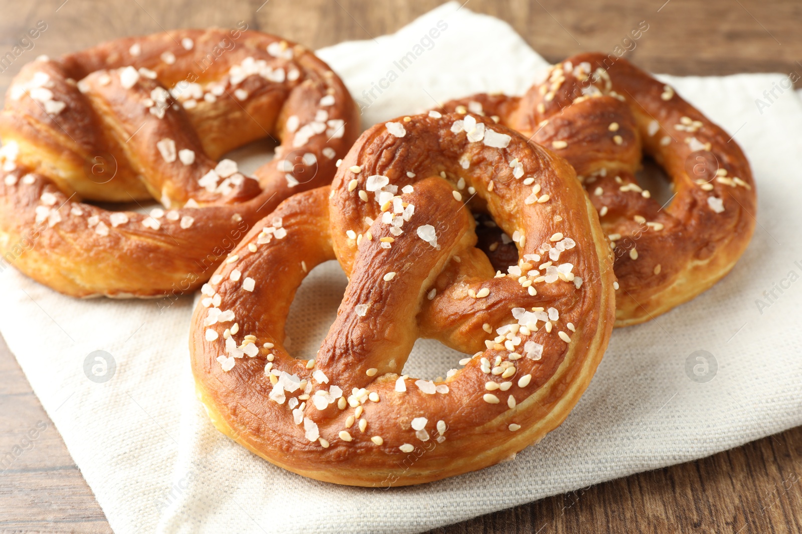 Tasty pretzels with salt on wooden table, closeup Photo of Tasty pretzels with salt on wooden table, closeup