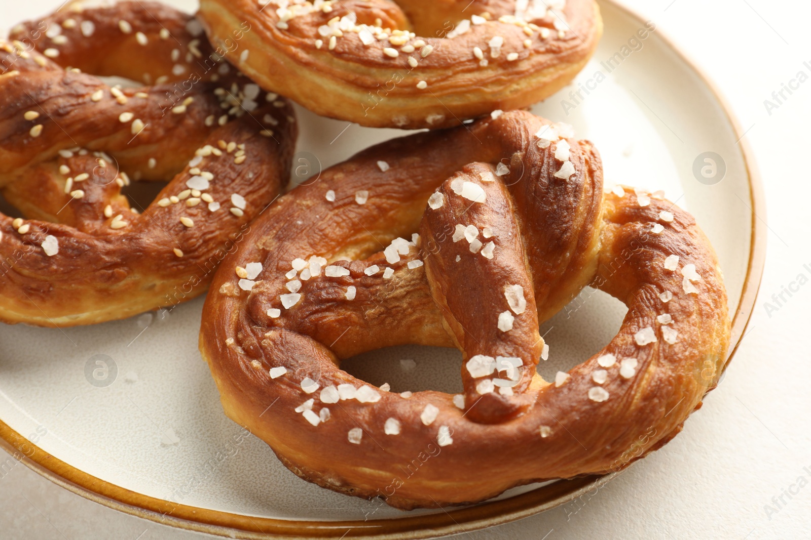 Tasty pretzels with salt on white table, closeup Photo of Tasty pretzels with salt on white table, closeup