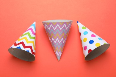Photo of Beautiful party hats on red background, flat lay