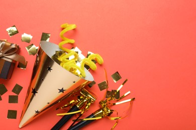 Photo of Beautiful party hat and other festive decor on red background, flat lay. Space for text