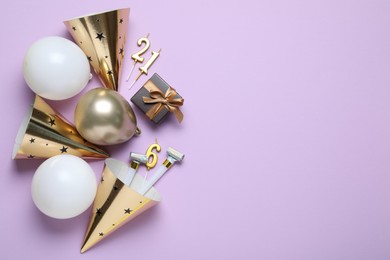 Photo of Beautiful party hats and other festive decor on violet background, flat lay. Space for text