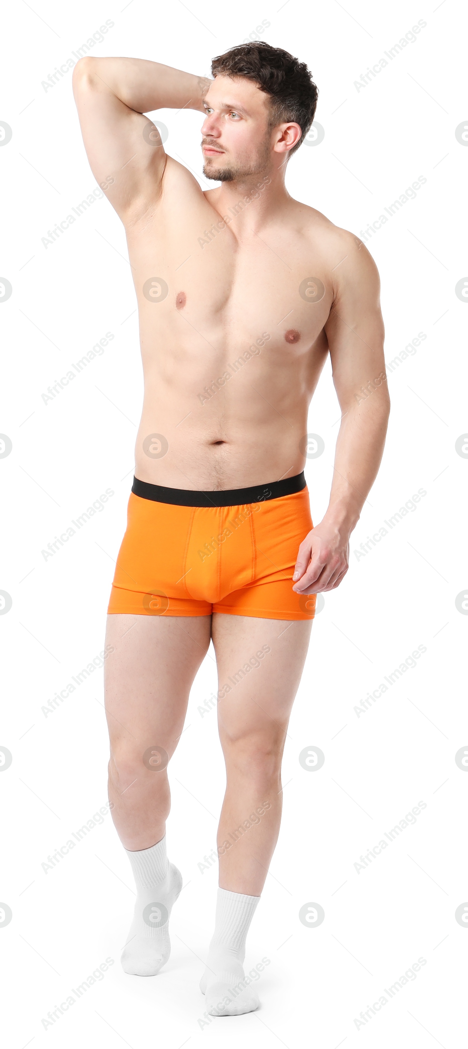 Young man in stylish orange underwear on white background Photo of Young man in stylish orange underwear on white background