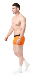 Photo of Young man in stylish orange underwear on white background