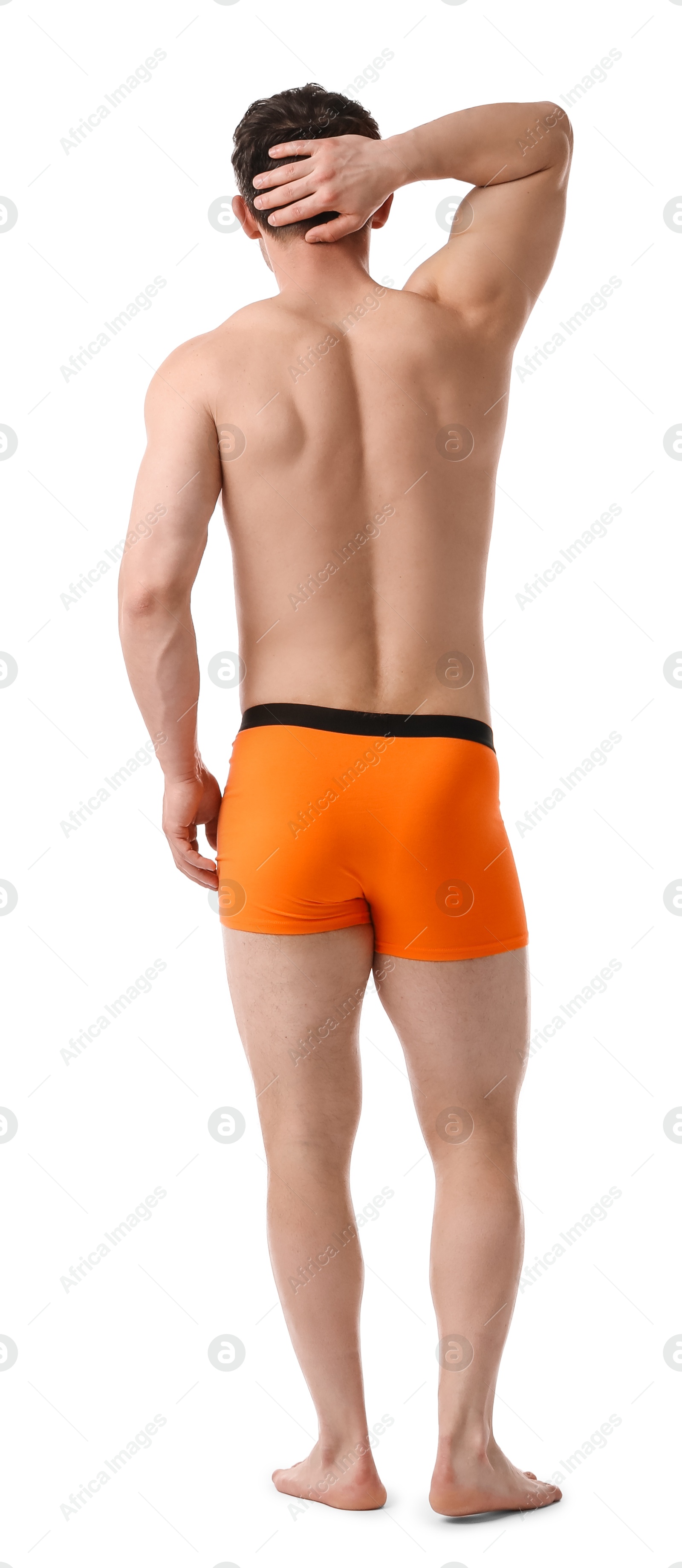 Young man in stylish orange underwear on white background, back view Photo of Young man in stylish orange underwear on white background, back view