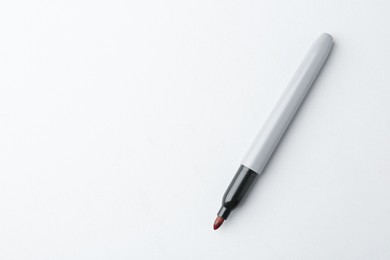 Photo of One red marker on light background, top view. Space for text