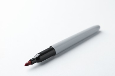 Photo of One red marker on light background, closeup. Space for text
